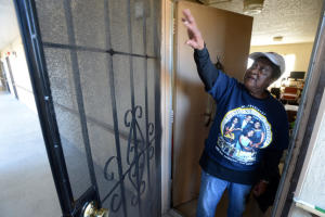 Hacienda resident Geneva Eaton talks about problems with the screen door on her unit at the public housing apartment complex in Richmond, Calif. on